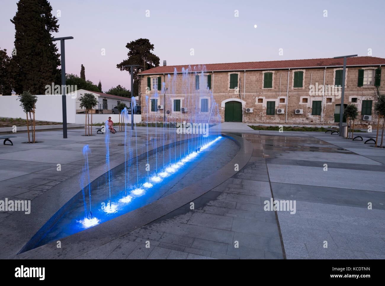 Floodlit water fountain beside the old police station in Kennedy Square, Paphos old town (Ktima), Cyprus. Stock Photo