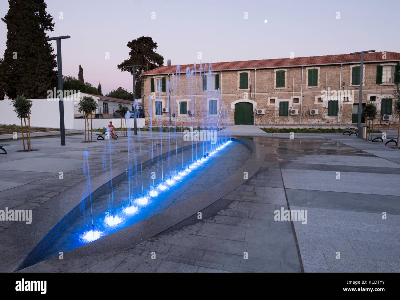 Floodlit water fountain beside the old police station in Kennedy Square, Paphos old town (Ktima), Cyprus. Stock Photo