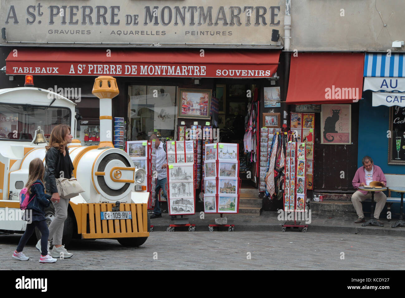 PARIS, FRANCE, SEPTEMBER 5, 2014 : Small train for tourists stops in front of souvenir stores. Montmartre is one of the most touristic district in Par Stock Photo