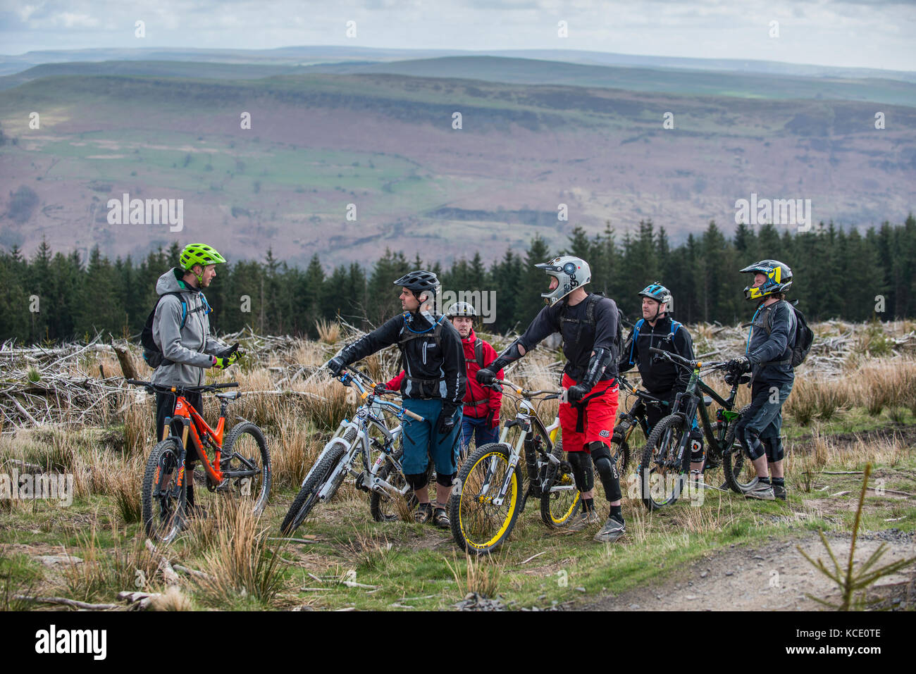 A mountain bike coach takes a group lesson at Bikepark Wales near