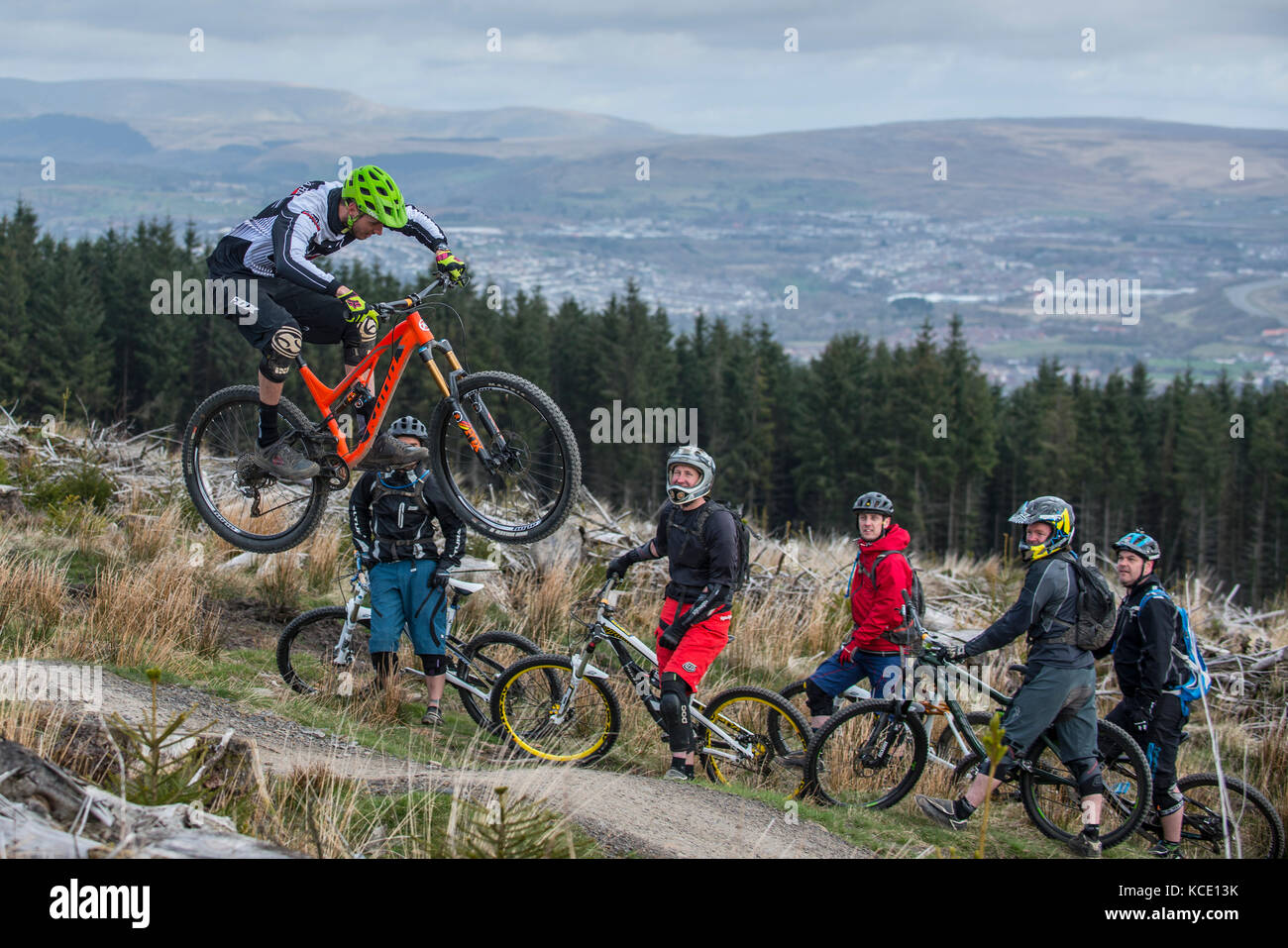 A mountain bike coach takes a group lesson at Bikepark Wales near