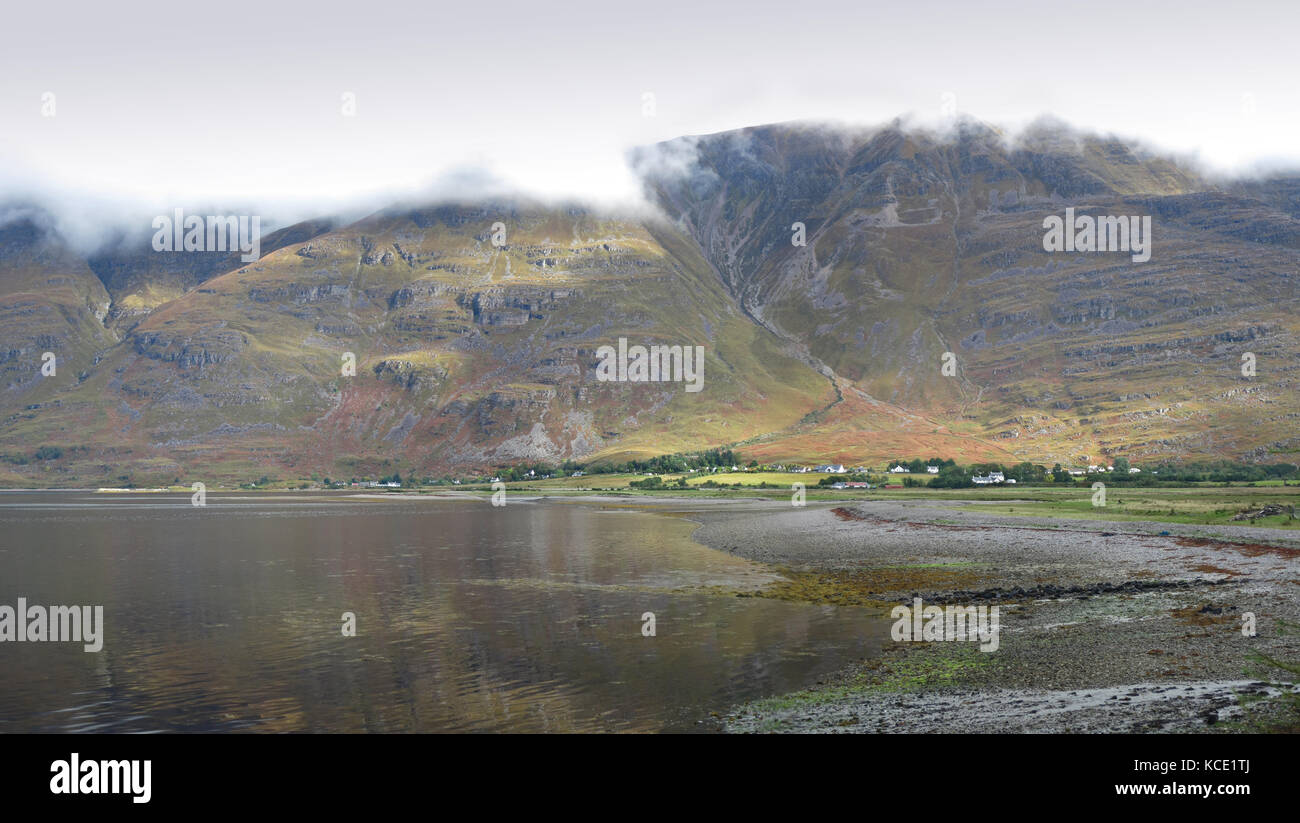 The village of Torridon in the western highlands of Scotland, UK. Viewed from the south across Loch Torridon. Shows peaks of Liathace & Beinn Eighe Stock Photo