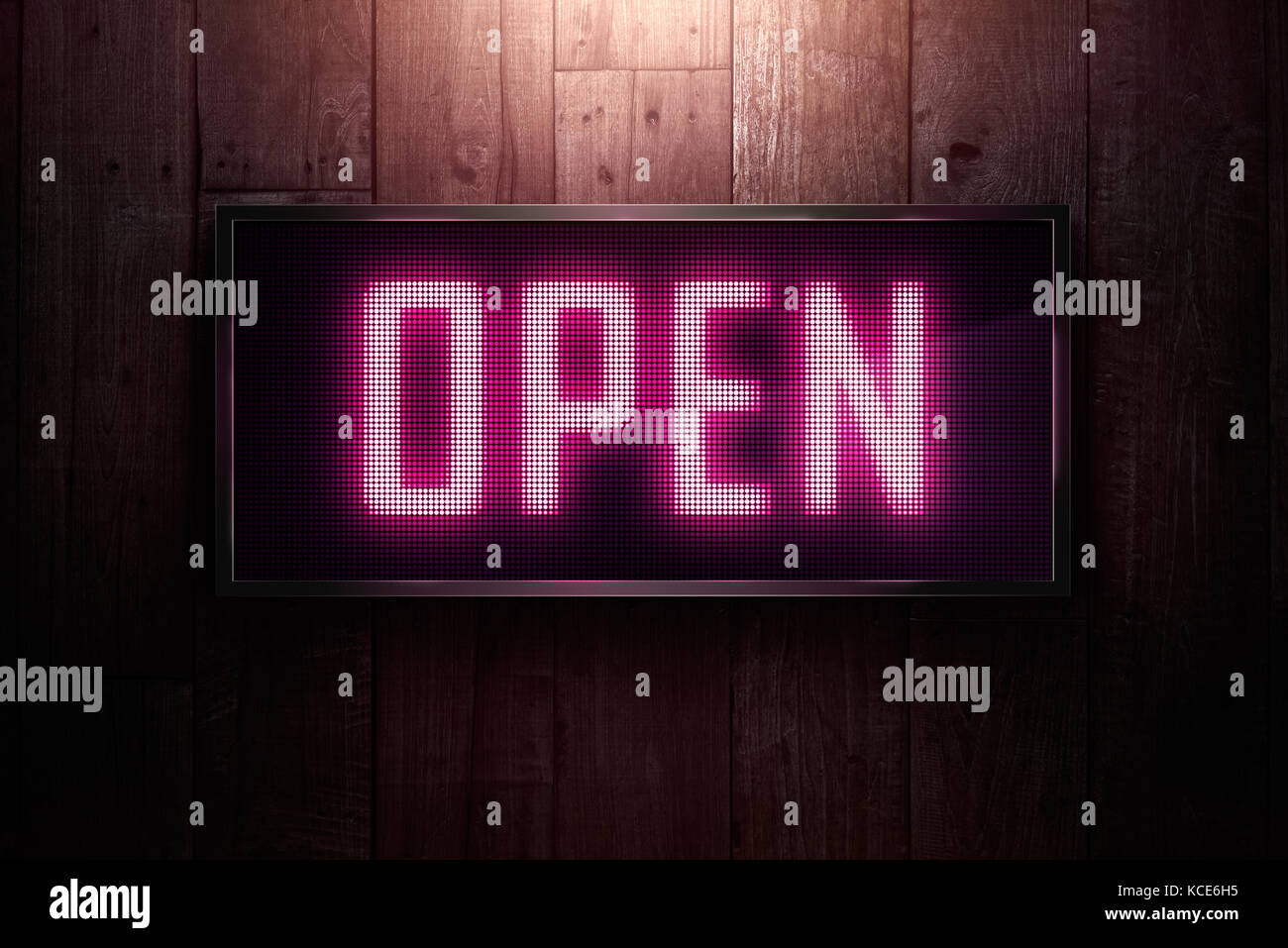 Open Led signage on wooden wall Stock Photo