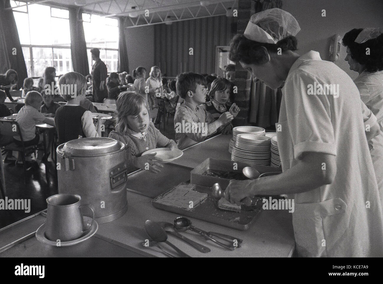 1970s, historical, school dinner ladies serving food to children at