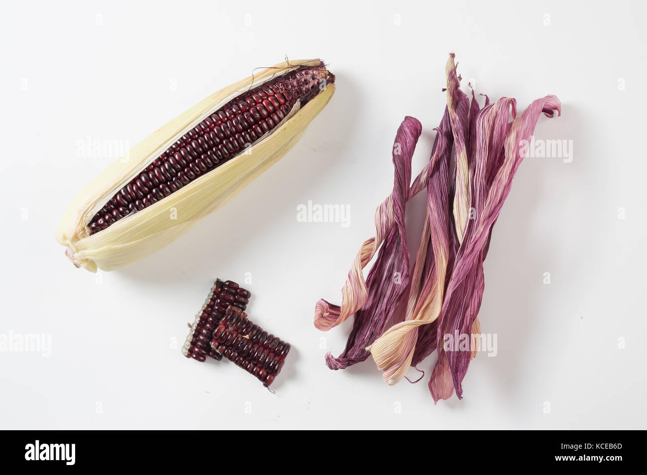 Black glutinous corn on white table with components including kernels and dried peels that can used to a wide range. Zero-waste kitchen and cooking co Stock Photo