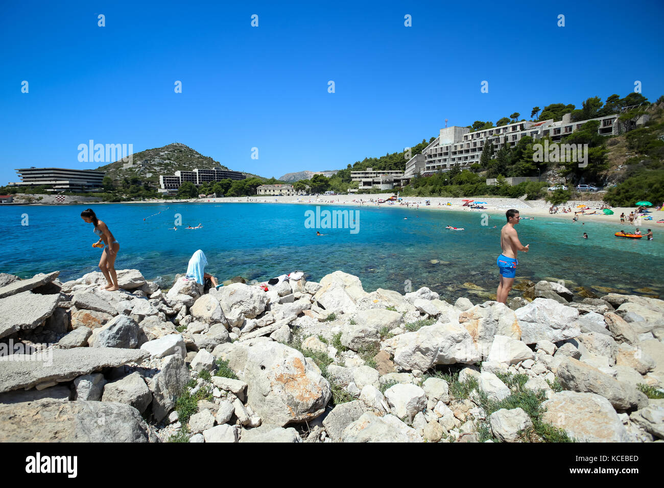 KUPARI, CROATIA - JULY 18, 2017 : People swimming and sunbathing on a rocky sea beach in Kupari, Croatia. Stock Photo