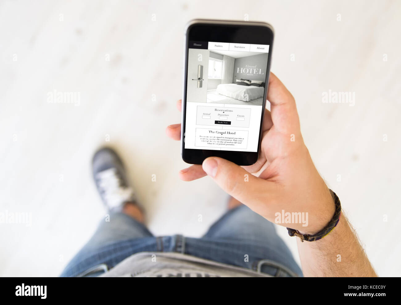 close up of male hand booking a room on smart phone Stock Photo - Alamy