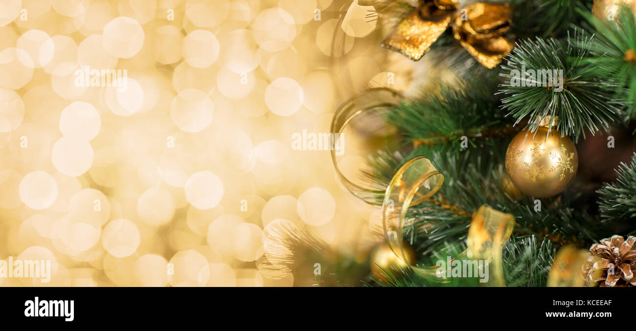 Christmas tree branch with blurred golden background Stock Photo