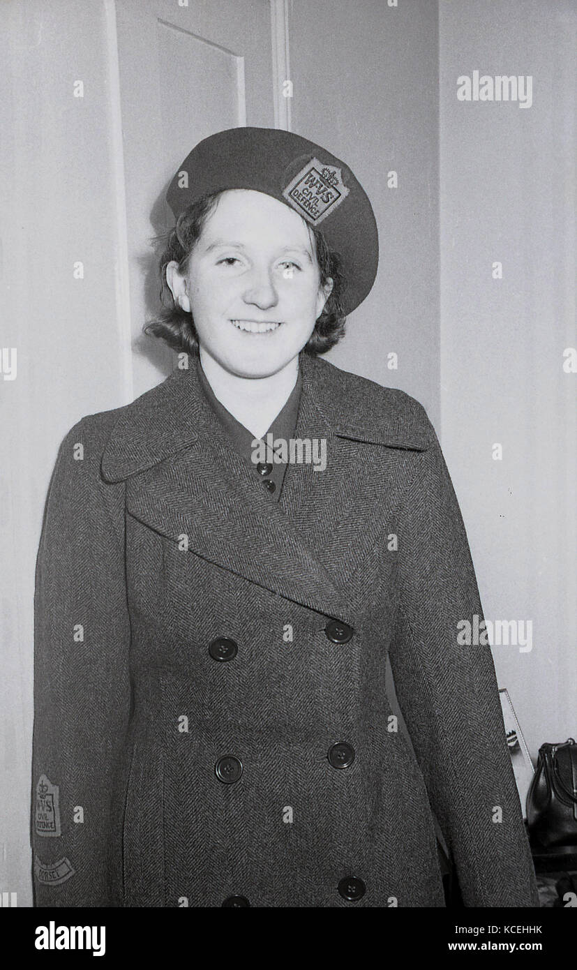Early 1960s, historical, a young female volunteer for the Women's charity organisation, the Women's Voluntary Services (WVS) shows off her uniform, Dorchester, England, UK. At the outbreak of war in September 1939 it some 300,000 female members and it's official name was the Women's Voluntary Services for Civil Defence, as this uniform shows. Stock Photo