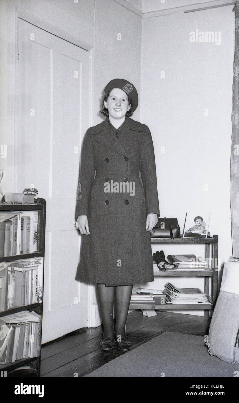 Early 1960s, historical, a young female volunteer for the Women's charity organisation, the Women's Voluntary Services (WVS) shows off her uniform, Dorchester, England, UK. At the outbreak of war in September 1939 it some 300,000 female members and it's official name was the Women's Voluntary Services for Civil Defence, as this uniform shows. Stock Photo