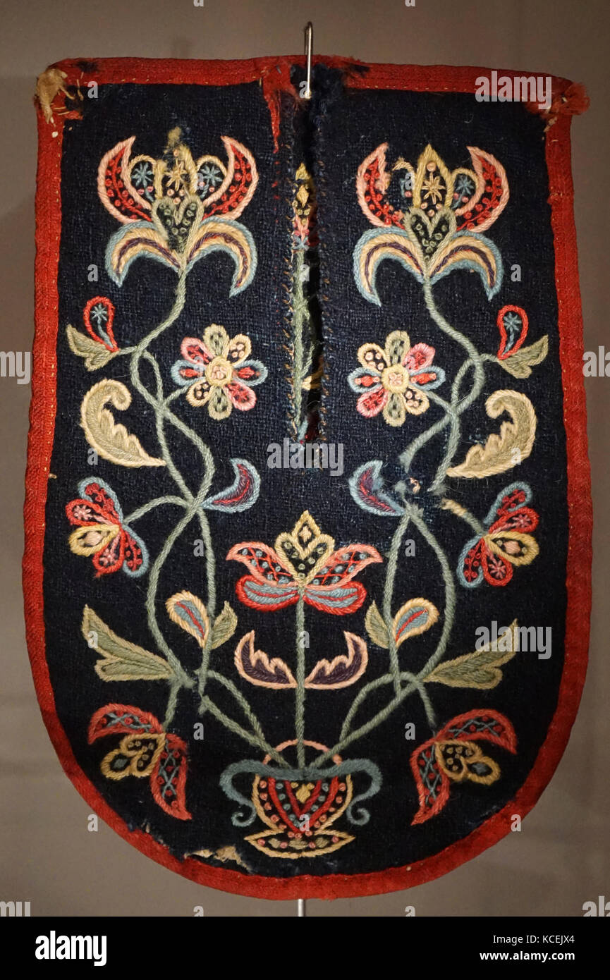 Icelandic, 18th century, traditional, ladies, formal clothing. made of imported fabrics  embroidered in gold or silver thread. Collar on an old style women’s costume, ornamented with metal thread embroidery, metal thread bobbin lace and beads. 19th century, Loose pocket, worn by women, with shaded floral embroidery in multi-coloured woollen yarn. Stock Photo