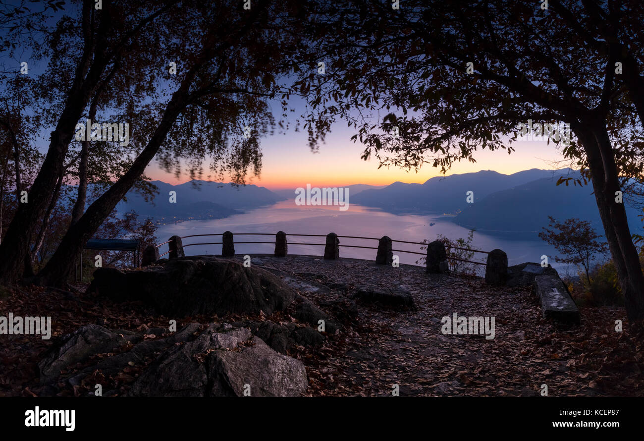 View of a sunset on Lake Maggiore from the viewpoint of the Giro del Sole trail, Agra, Veddasca valley, Varese district, Lombardy, Italy. Stock Photo