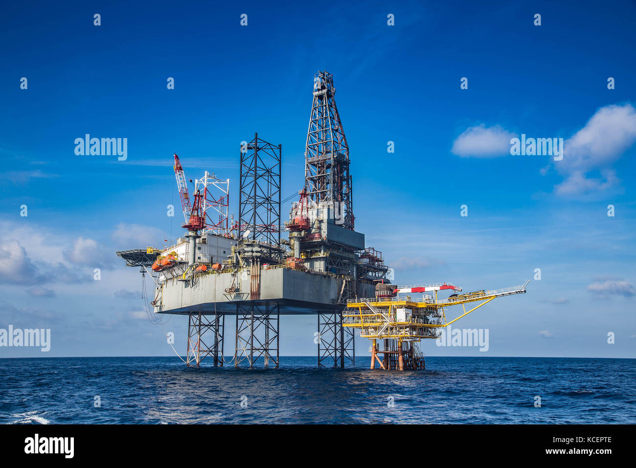 Offshore oil and gas drilling rig while completion well on oil and gas wellhead remote platform, energy production and exploration business. Stock Photo