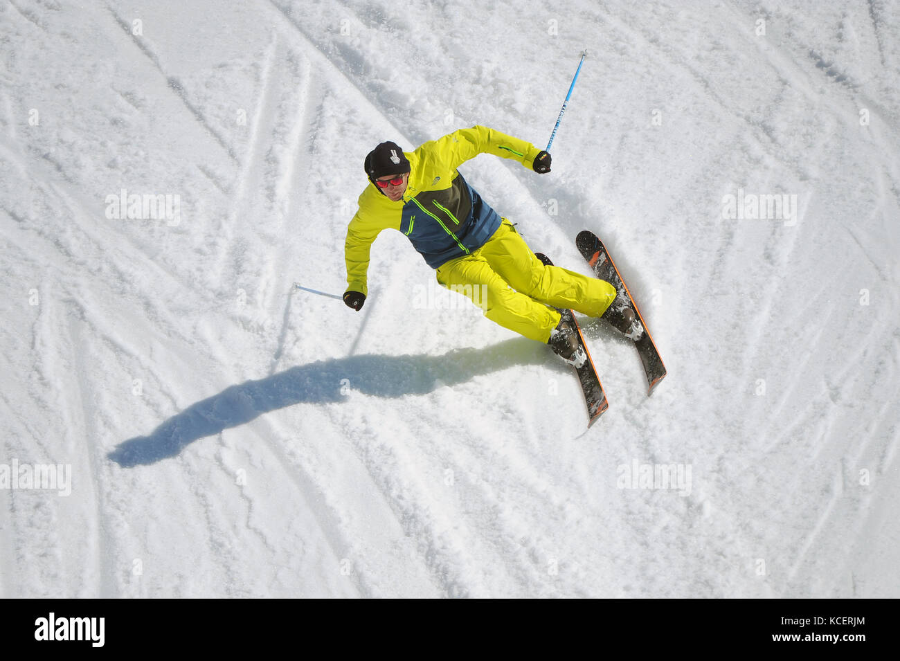 A skier carves a turn photographed from above. Stock Photo
