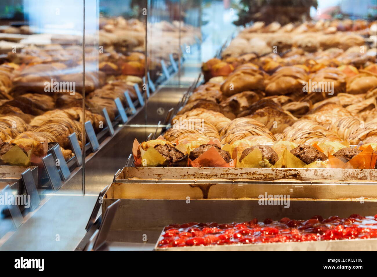 Variations croissants and other pastries exhibited in shop window Stock Photo