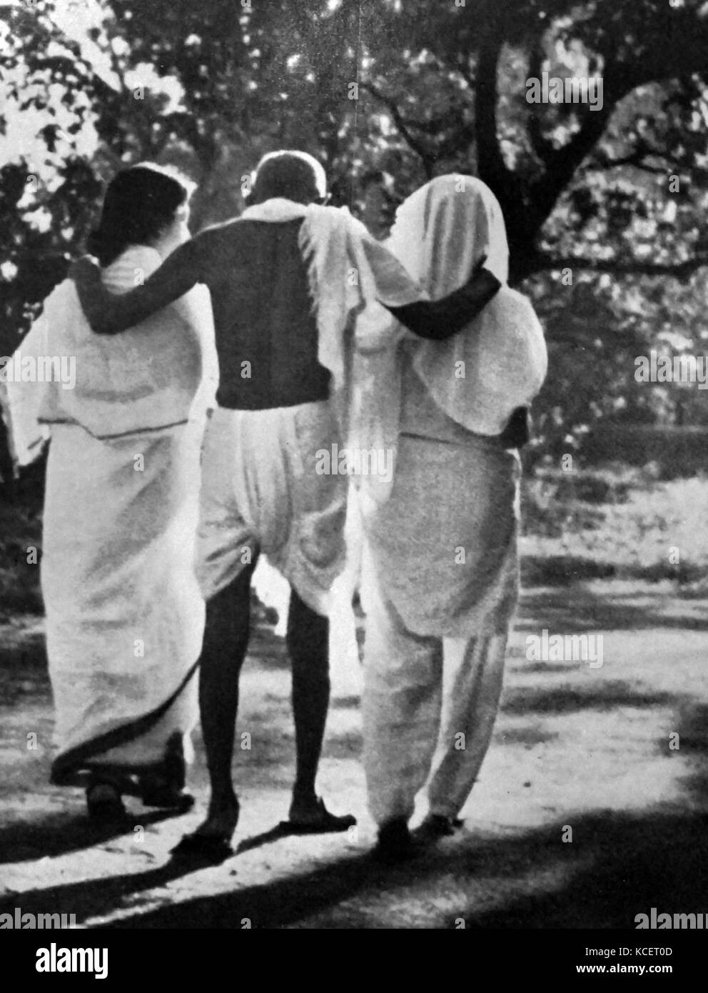 Mohandas Karamchand Gandhi with his nieces walking in a garden 1948. Gandhi (2 October 1869 – 30 January 1948), was the preeminent leader of the Indian independence movement in British-ruled India. Stock Photo