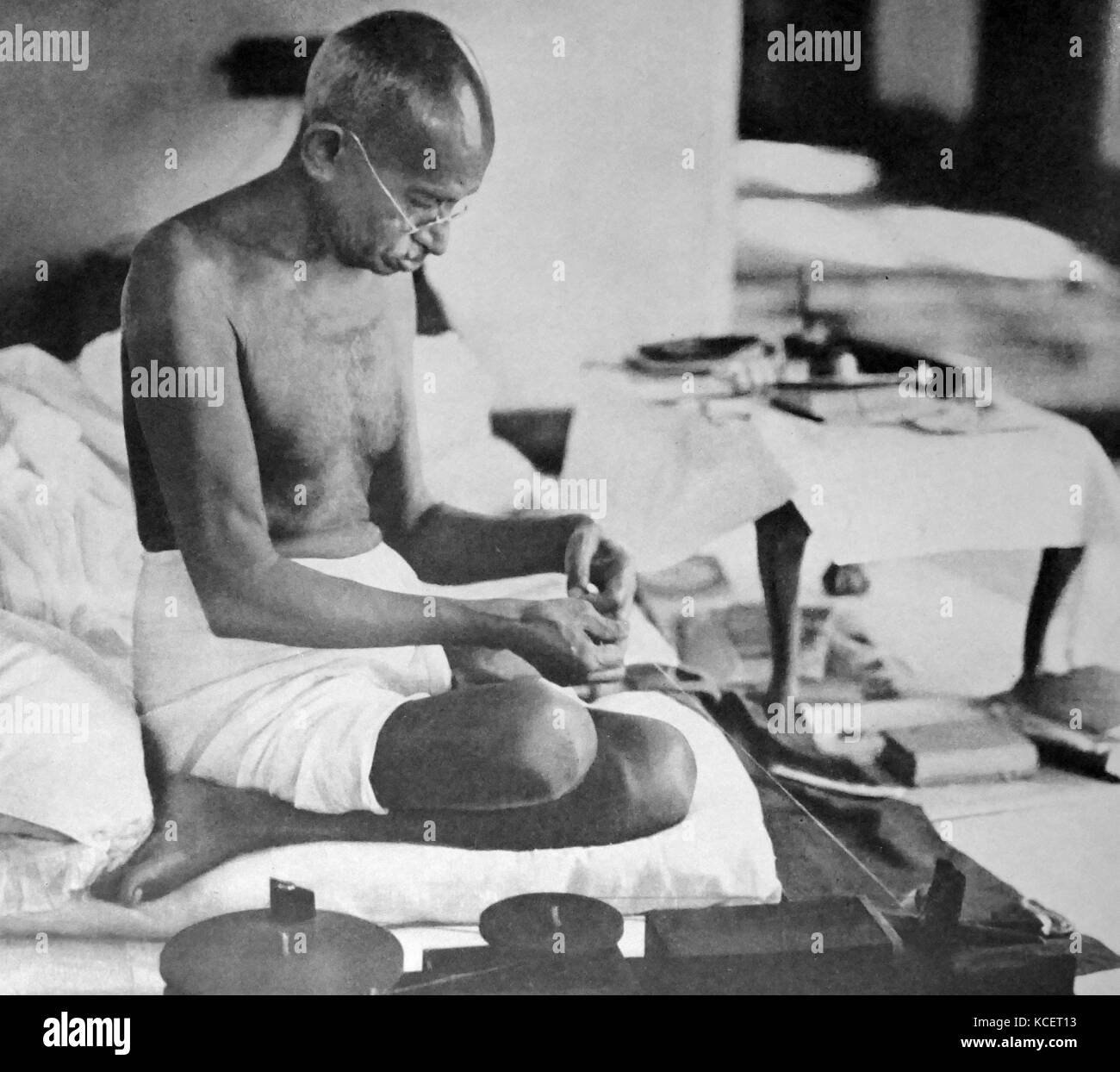 Mohandas Karamchand Gandhi spins cloth using traditional methods; Bombay 1945. Gandhi (2 October 1869 – 30 January 1948), was the preeminent leader of the Indian independence movement in British-ruled India. Stock Photo