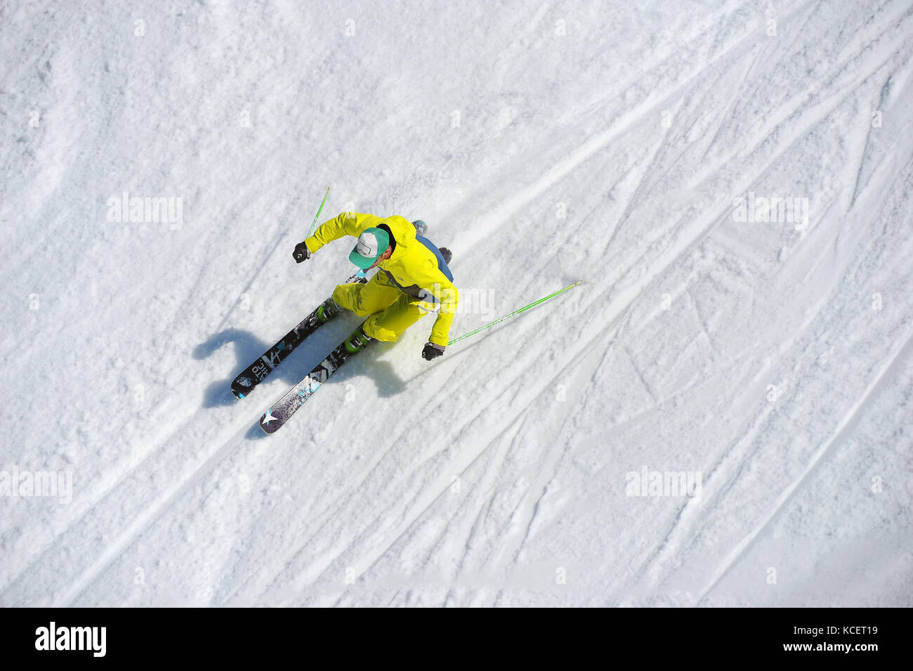 A skier carves a turn photographed from above. Stock Photo