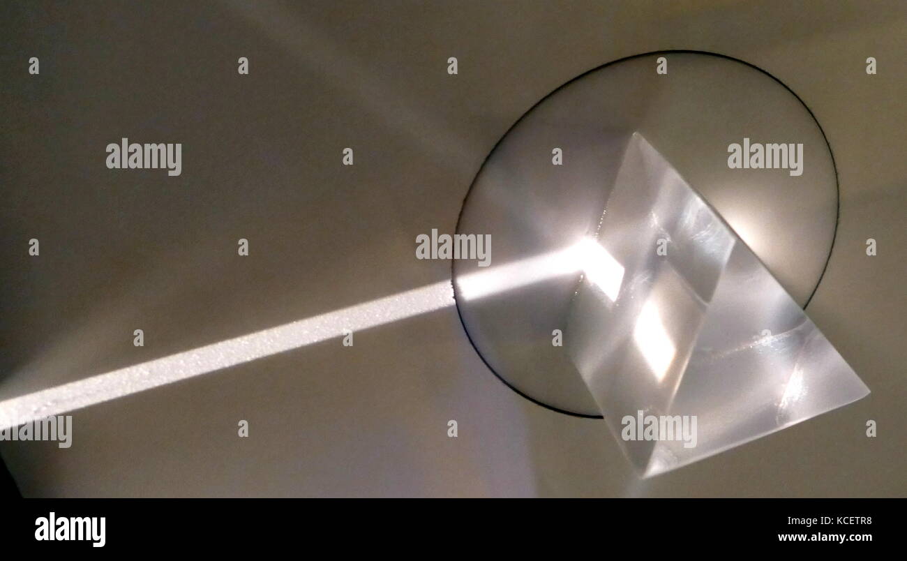In optics, a prism is a transparent optical element with flat, polished surfaces that refract light. At least two of the flat surfaces must have an angle between them. The exact angles between the surfaces depend on the application. The traditional geometrical shape is that of a triangular prism with a triangular base and rectangular sides, and in colloquial use 'prism' usually refers to this type. Stock Photo