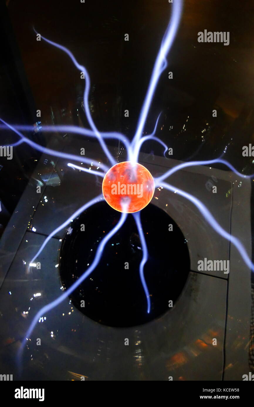 A plasma globe or plasma lamp (also called plasma ball, dome, sphere, tube or orb, depending on shape) is (usually) a clear glass sphere filled with a mixture of various noble gases with a high-voltage electrode in the center of the sphere. Plasma filaments extend from the inner electrode to the outer glass insulator, giving the appearance of multiple constant beams of coloured light. The plasma lamp was invented by Nikola Tesla. Stock Photo