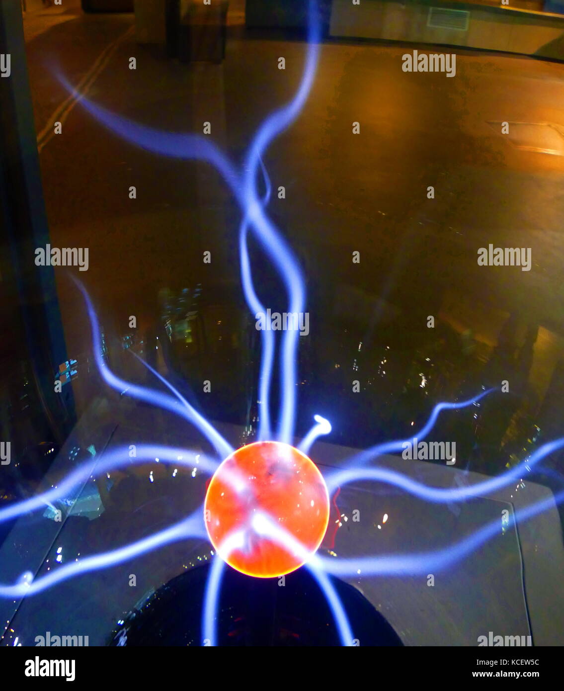 A plasma globe or plasma lamp (also called plasma ball, dome, sphere, tube or orb, depending on shape) is (usually) a clear glass sphere filled with a mixture of various noble gases with a high-voltage electrode in the center of the sphere. Plasma filaments extend from the inner electrode to the outer glass insulator, giving the appearance of multiple constant beams of coloured light. The plasma lamp was invented by Nikola Tesla. Stock Photo