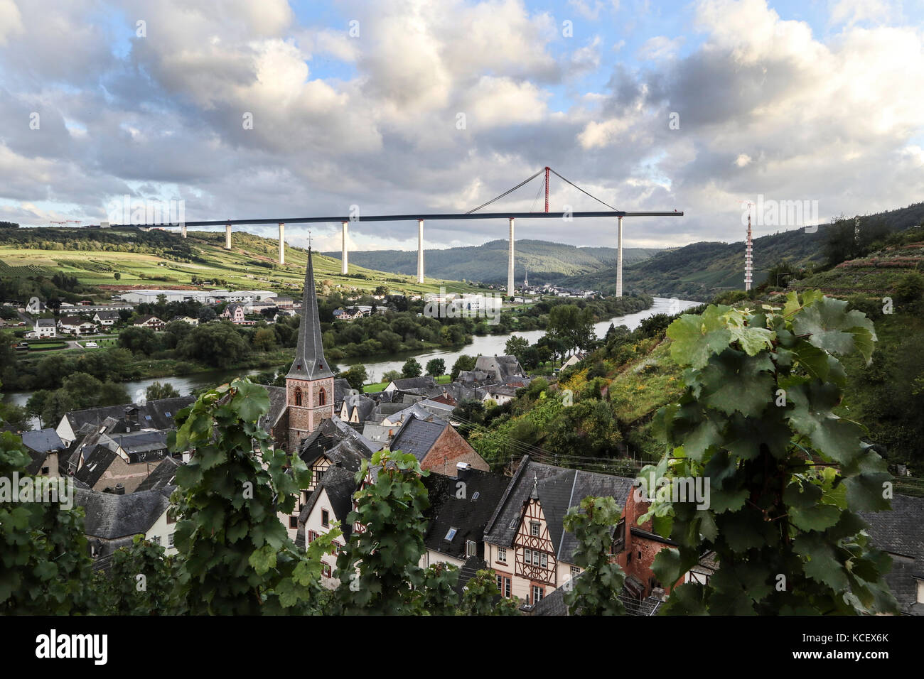 The town of Urzig, in the Mosel Valley, Germany, with the unfinished Autobahn bridge crossing the valley in the distance Stock Photo