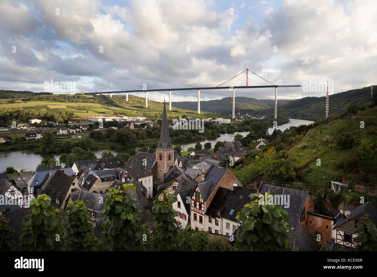 The town of Urzig, in the Mosel Valley, Germany, with the unfinished Autobahn bridge crossing the valley in the distance Stock Photo