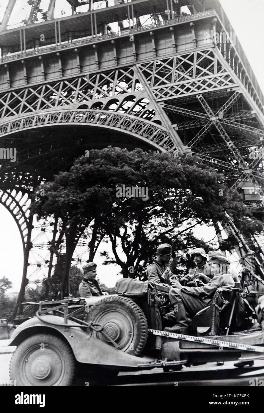 World War Two: German soldiers sit in a vehicle under the Eiffel Tower as they occupy Paris, during the invasion of France 1940. Dated 20th Century Stock Photo
