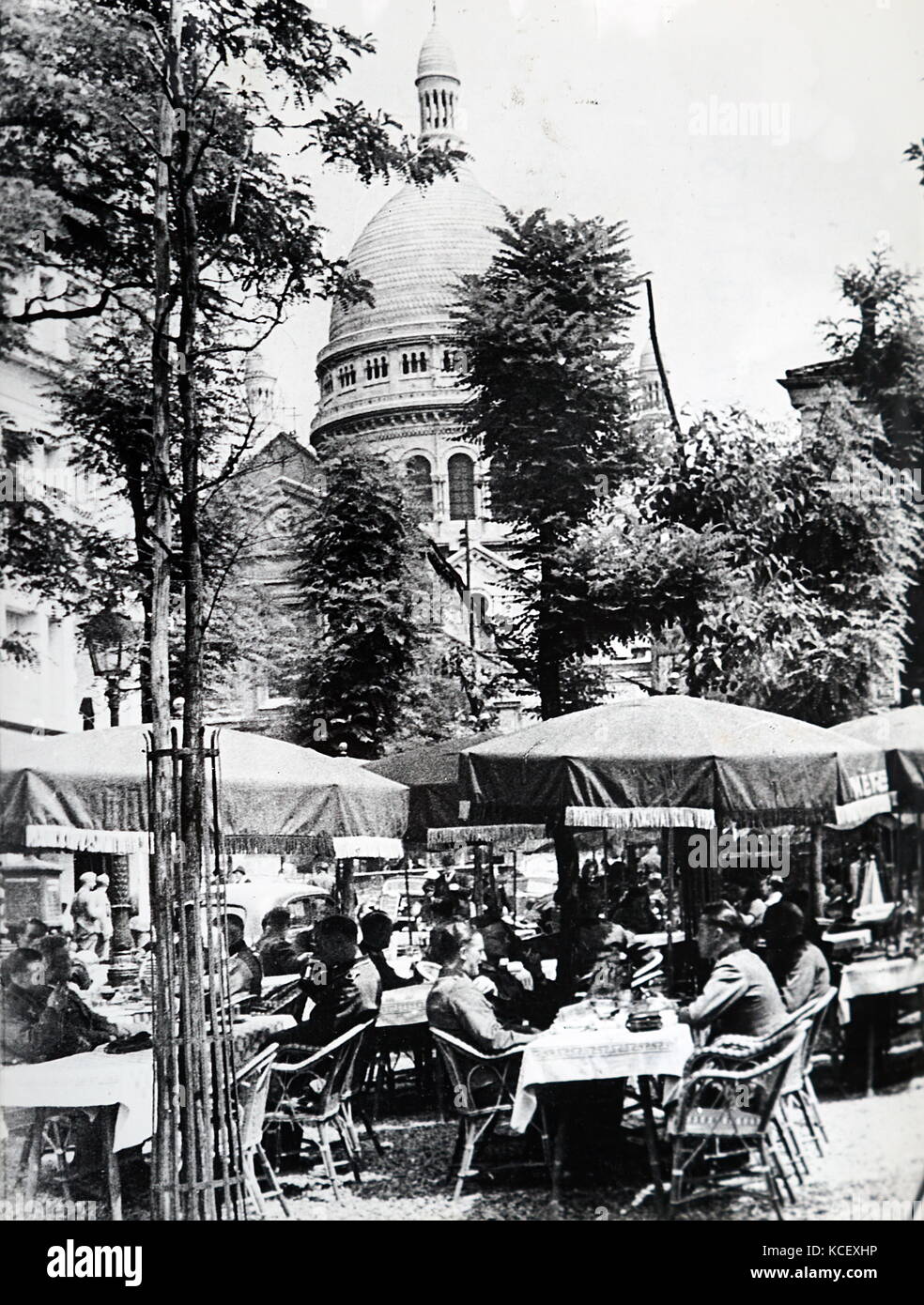 Photograph of German officers relaxing at a café in Montmartre near the Sacre Coeur, in Paris, after the Invasion of France in 1940, in World War Two. Dated 20th Century Stock Photo