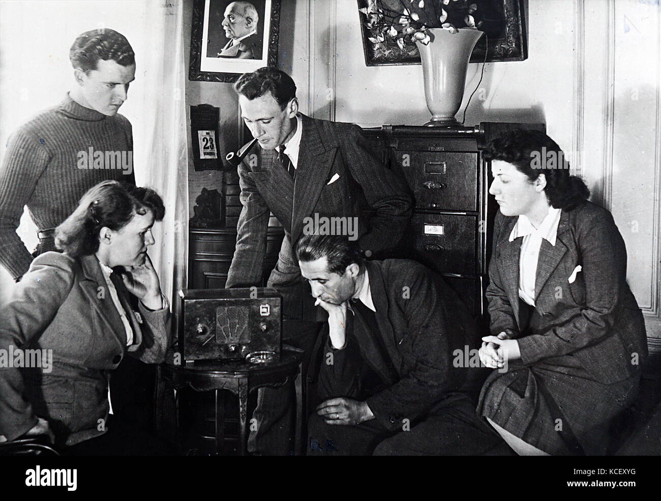 Photograph of Vichy French civilians listen to a radio broadcast by Admiral Jean Darlan (1881 – 1942) , French Admiral and political figure. He was Admiral of the Fleet and commander in chief of the French Navy in 1939 at the beginning of World War II. After France capitulated to Nazi Germany in 1940, Darlan served in the pro-German Vichy regime, becoming its deputy leader for a time Stock Photo