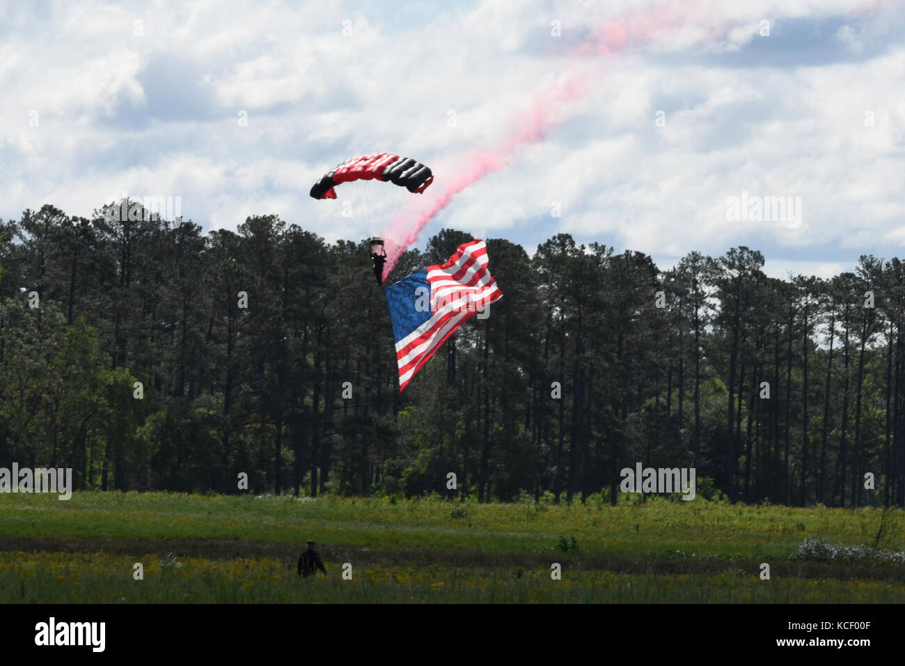 Soldiers with the Black Daggers, the official U.S. Army Special Operations Command Parachute Demonstration Team, deliver the American Flag during the opening ceremony for the South Carolina Guard Air &amp; Ground Expo at McEntire Joint National Guard Base, South Carolina, May 6, 2017. This expo is to showcase the abilities of South Carolina National Guard Airmen and Soldiers while saying thank you for the support of fellow South Carolinians and the surrounding community. (U.S. Army National Guard photo by Sgt. Brian Calhoun) Stock Photo