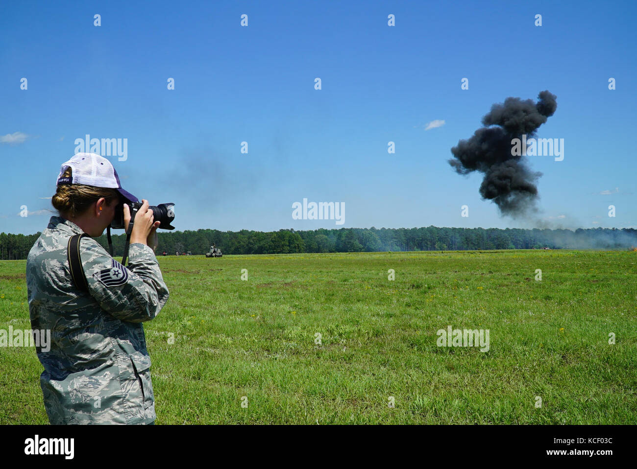 U.S. Air Force Tech Sgt. Nicole Szews from the 169th Fighter Wing Public Affairs Team captures images during the South Carolina National Guard Air and Ground Expo at McEntire Joint National Guard Base, South Carolina, May 6, 2017. This expo is a combined arms demonstration showcasing the abilities of South Carolina National Guard Airmen and Soldiers while saying thank you for the support of fellow South Carolinians and the surrounding community. (U.S. Army National Guard photo by Capt. Brian Hare) Stock Photo