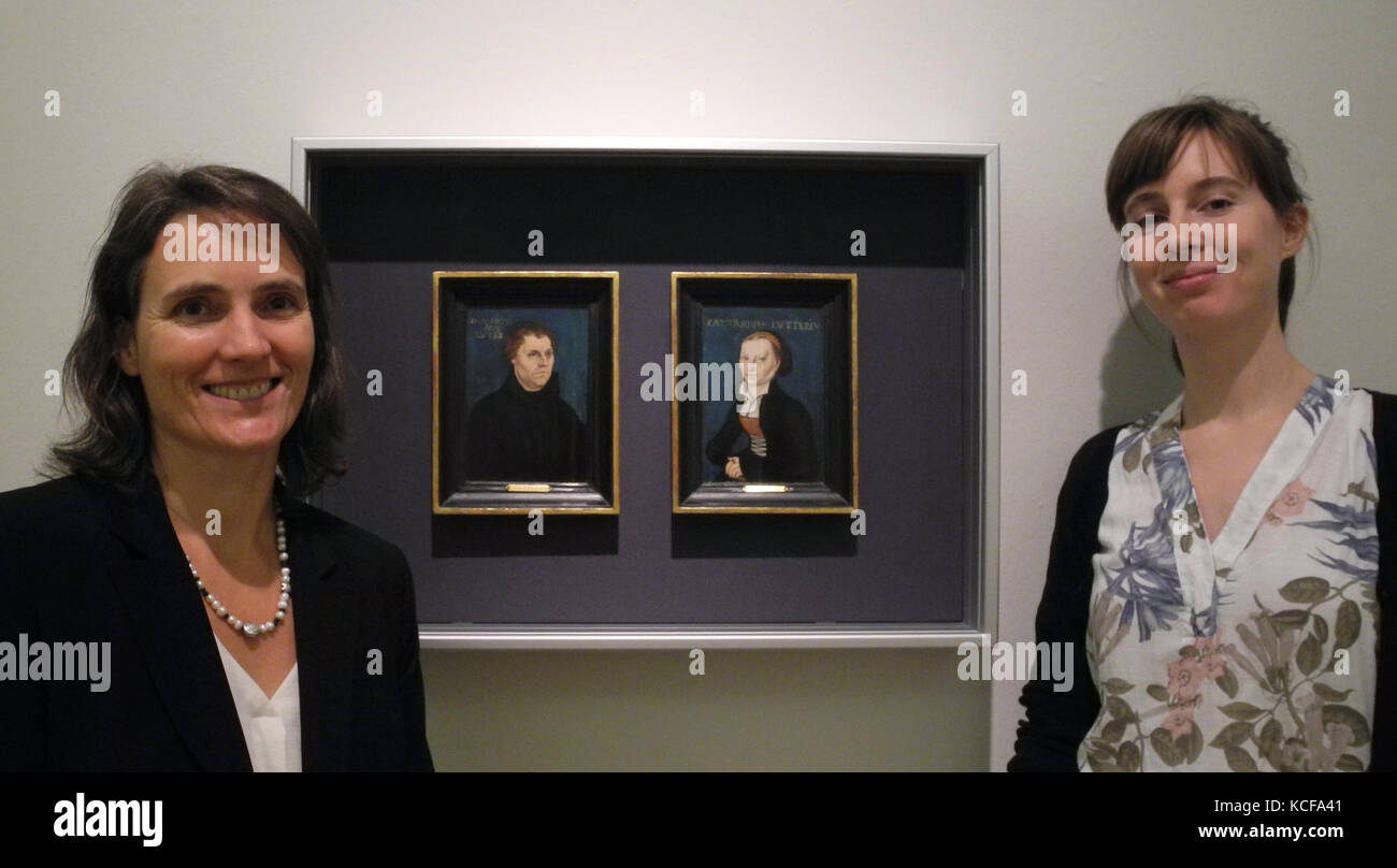 Schleswig, Germany. 04th Oct, 2017. The curator Uta Kuhl (L) and the scientifc assistant Constanze Koester standing beside a portrait of Martin Luther (L) and his wife Katharina von Bora, painted by Lucas Cranach the Elder, at castle Gottorf in Schleswig, Germany, 04 October 2017. The exhibition 'Luther's North' is dedicated to the influence of the reformation on North Germany and the Baltic Region. Credit: Birgitta von Gyldenfeldt/dpa/Alamy Live News Stock Photo