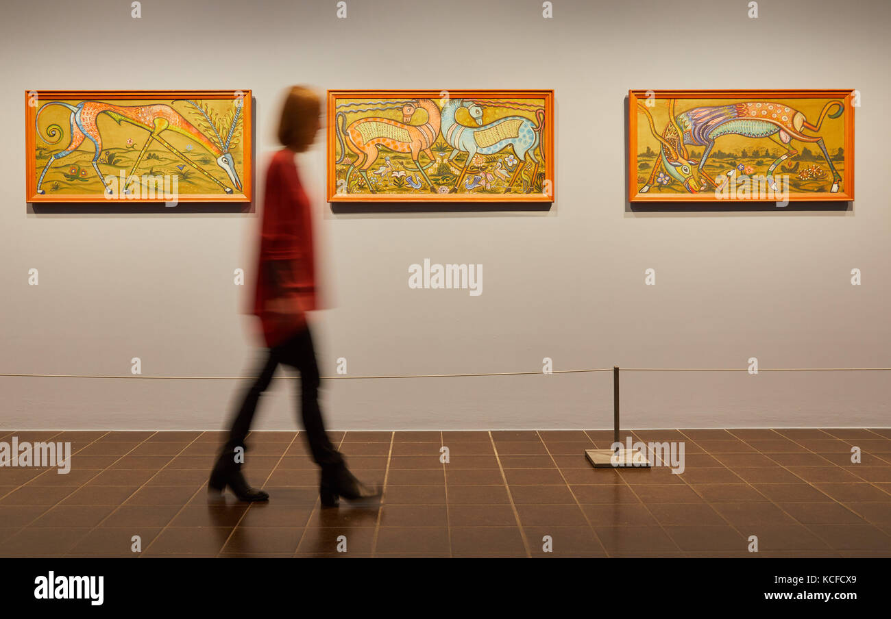 A staff members looks at the paintings 'Fabeltier nach rechts' (l-r), 'Zwei Fabeltiere' and 'Fabeltier nach links' by Hamburg-based artist Anita Rée (1885-1933) during a press call for the first extensive museum exhibition of the painter at the Kunsthalle ('art hall') in Hamburg, Germany, 5 October 2017. The exhibition with around 200 paintings, works on paper and designed objects can be seen until 4 February 2018. Photo: Georg Wendt/dpa Stock Photo