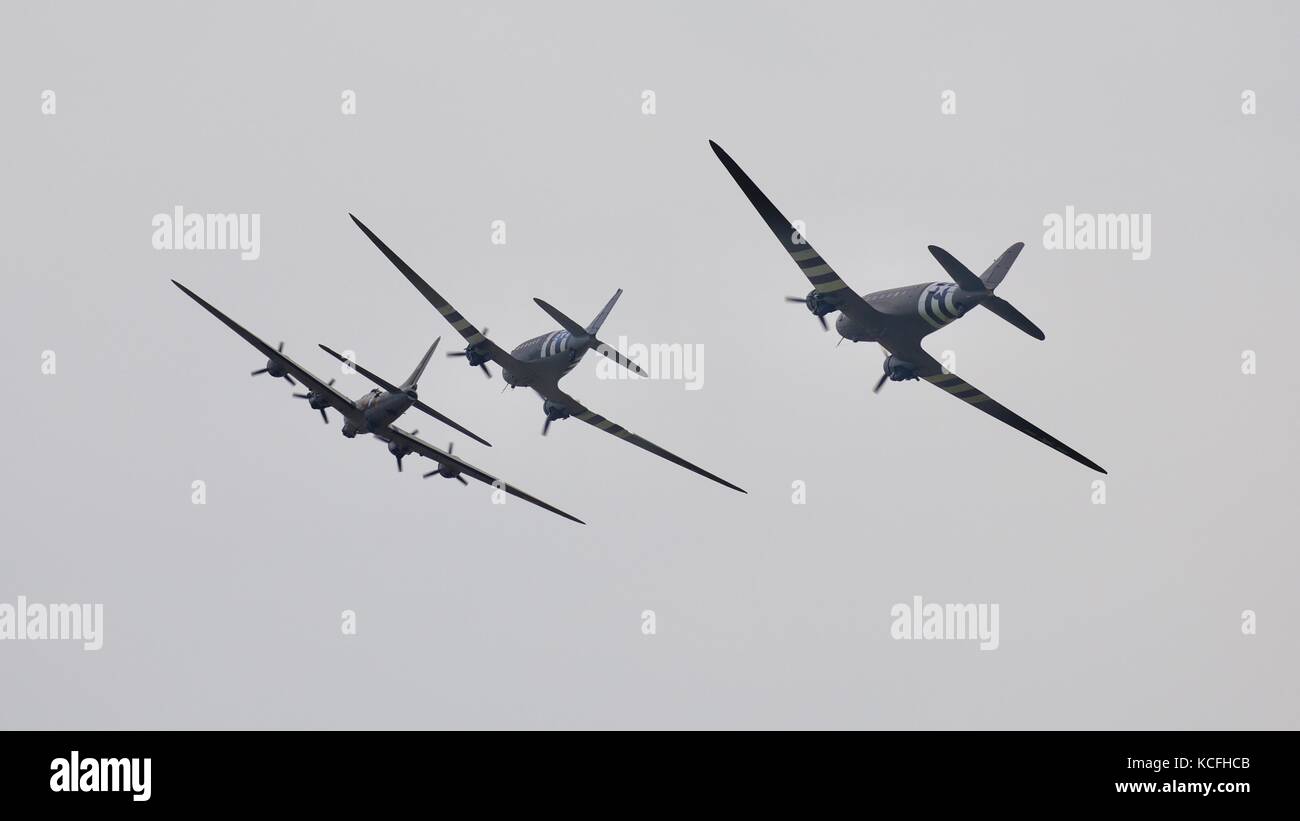 Boeing b-17 Flying Fortress and two Douglas C-47 Skytrain aircraft flying in formation at Duxford 2017 Battle of Britain air show Stock Photo