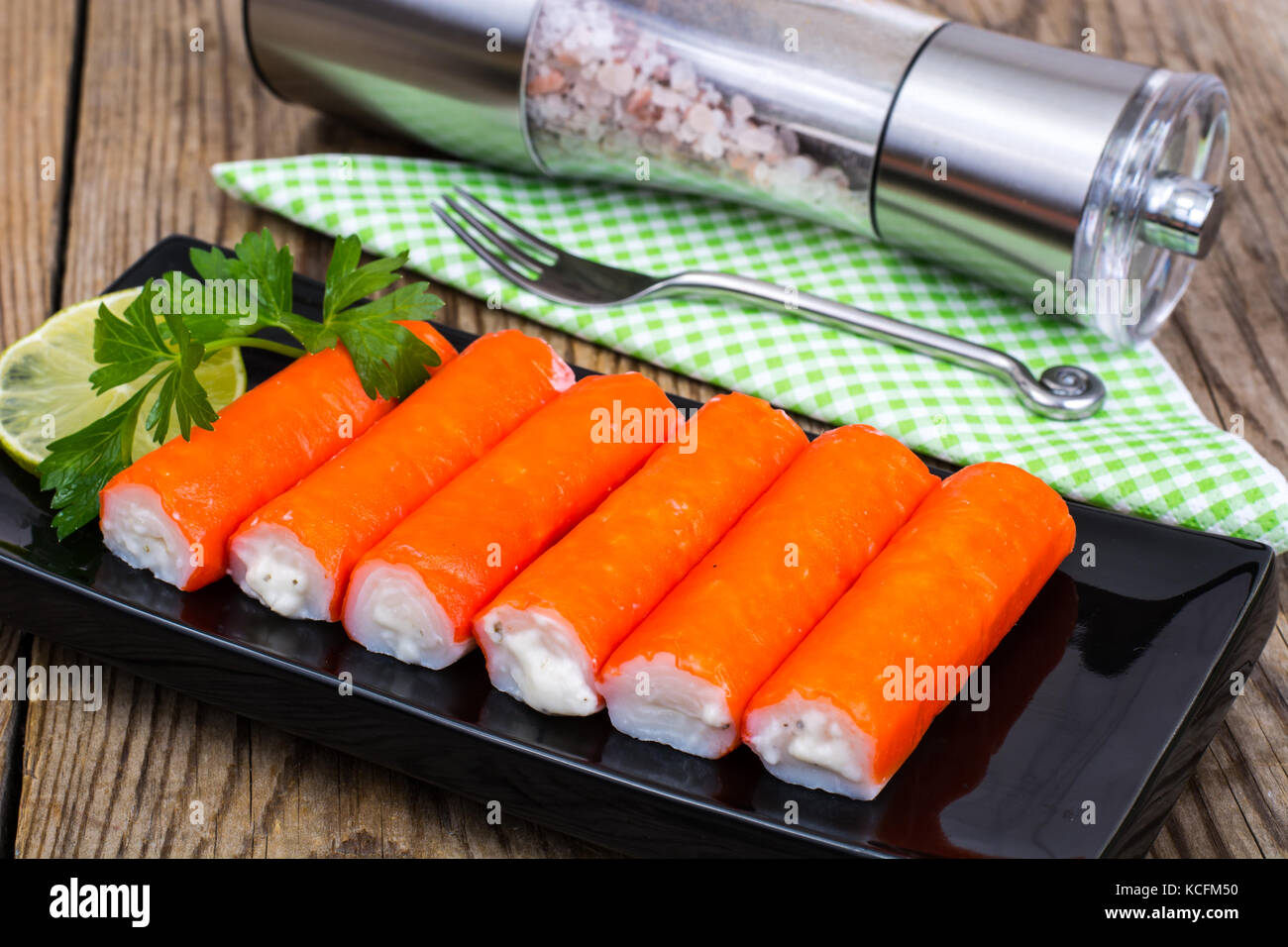 Surimicrab sticks on black plate Stock Photo Alamy