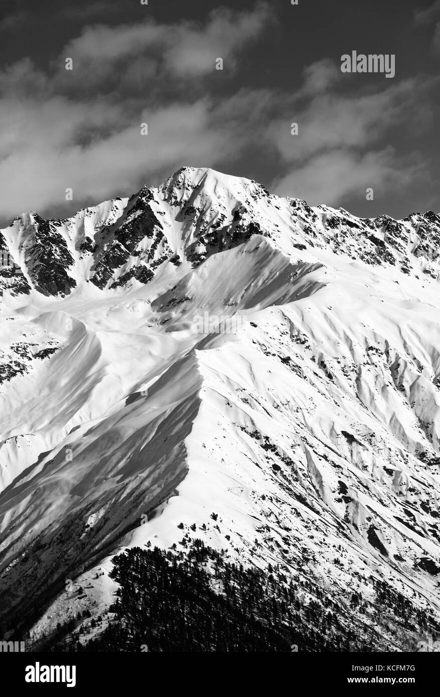 Black and white snow mountain peak at sunny day. View from chair lift on Hatsvali, Svaneti region of Georgia. Caucasus Mountains in winter. Stock Photo