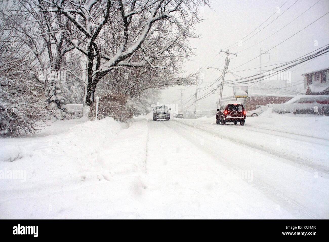 Snow plows work hard to clear deep snow on roads following a blizzard