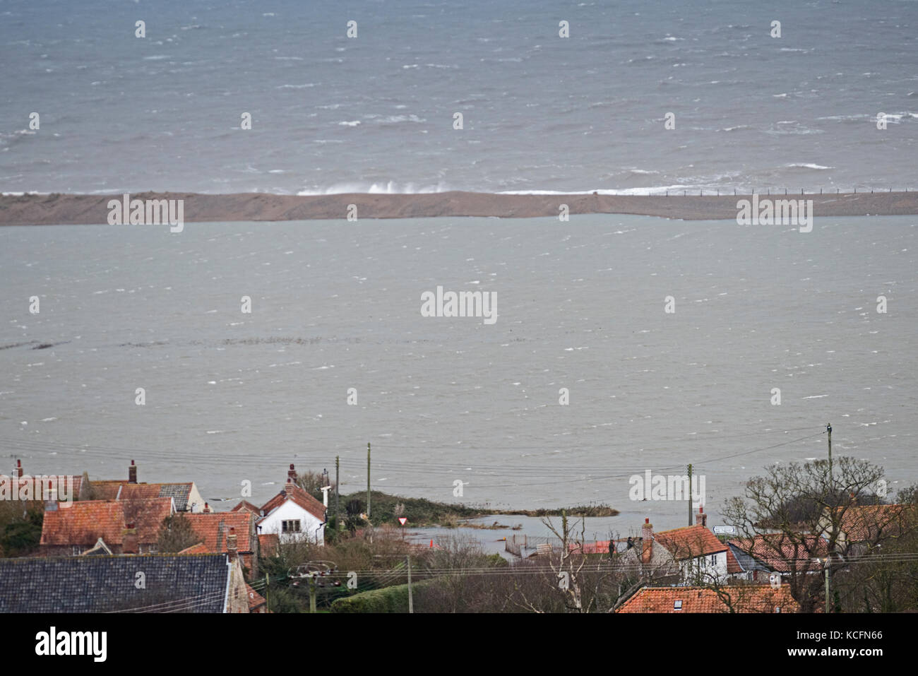 Salthouse Marshes (salthouse village in foreground) on North Norfolk coast flooded after Friday January 13th 2017 North Sea surge Stock Photo