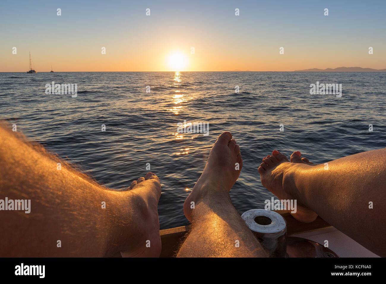 Feets Sunset Feet of couple with sunset and view to the sea. Santorini, Greece Stock ...