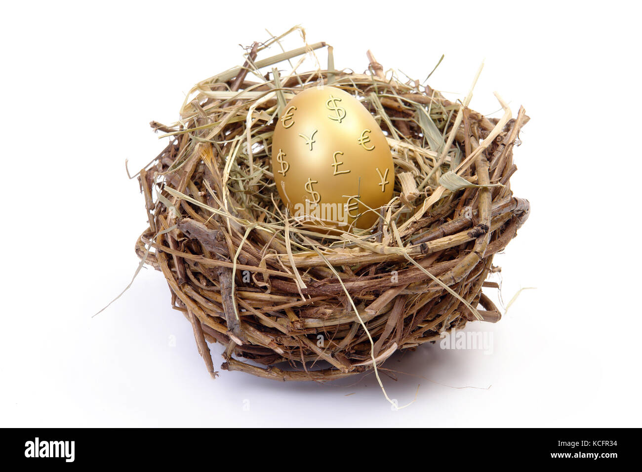 Golden egg with euro, dollar, yen and pound sterling symbols in bird's nest over white background Stock Photo