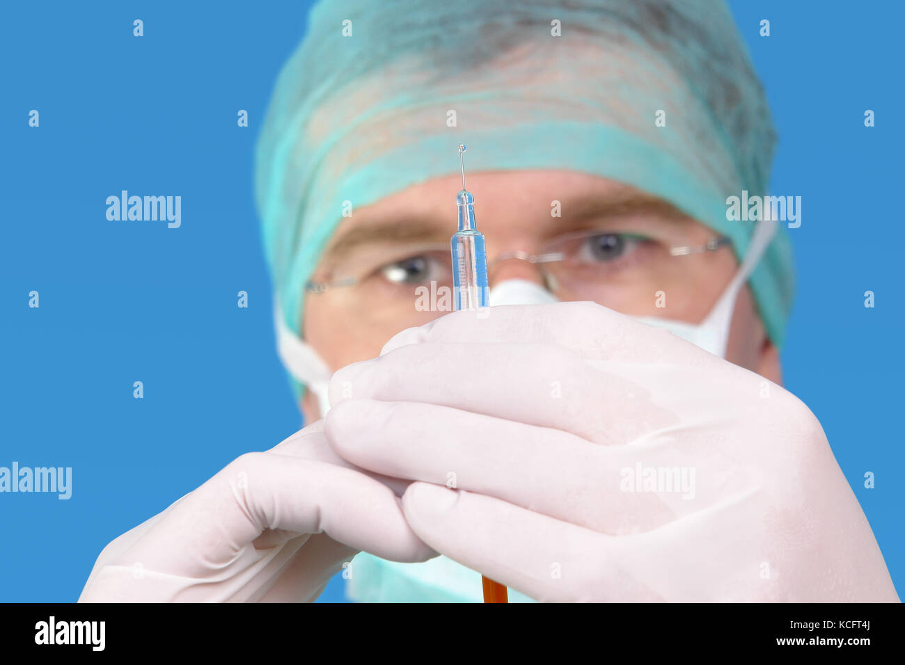 Closeup of surgeon preparing syringe for injection - shallow depth of field Stock Photo