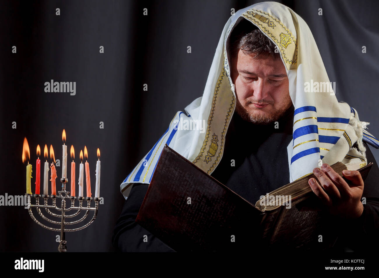 jewish man with beard lighting the candles Jewish man in prayer of a