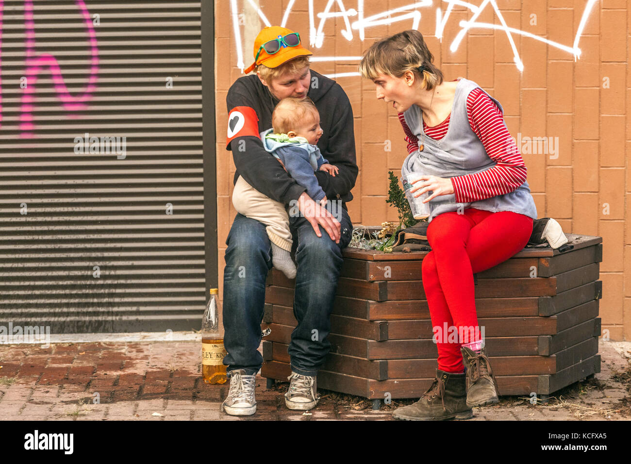 Young parents with baby discussing on the street, Prague, Czech Republic Stock Photo