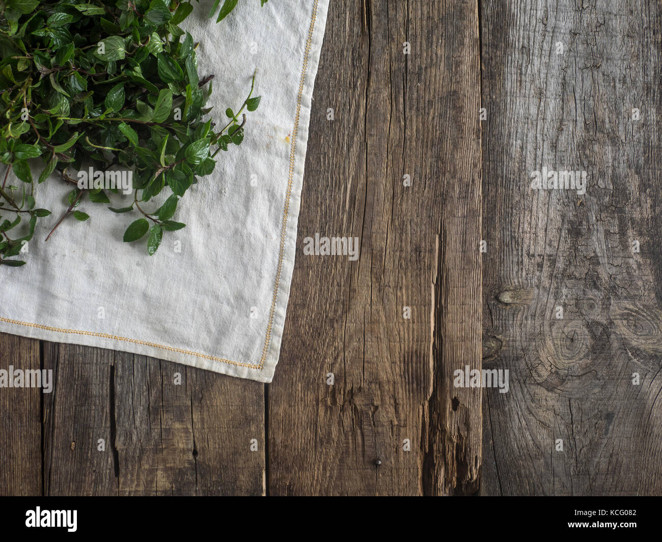 Fresh mint leaves on old weathered wooden background Stock Photo - Alamy