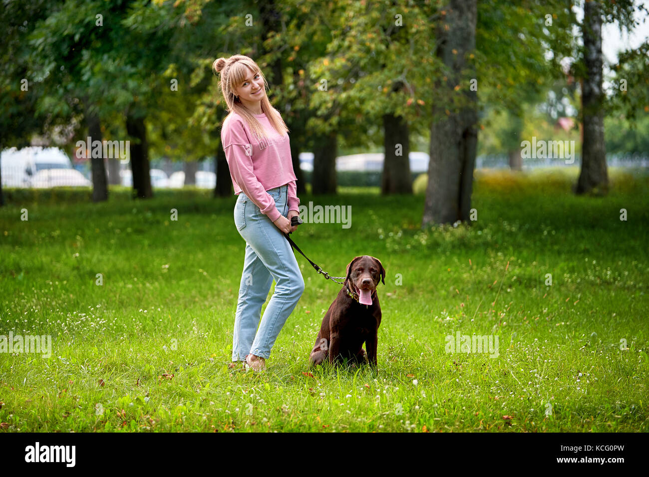 smiling girl relaxing with dog. Stock Photo