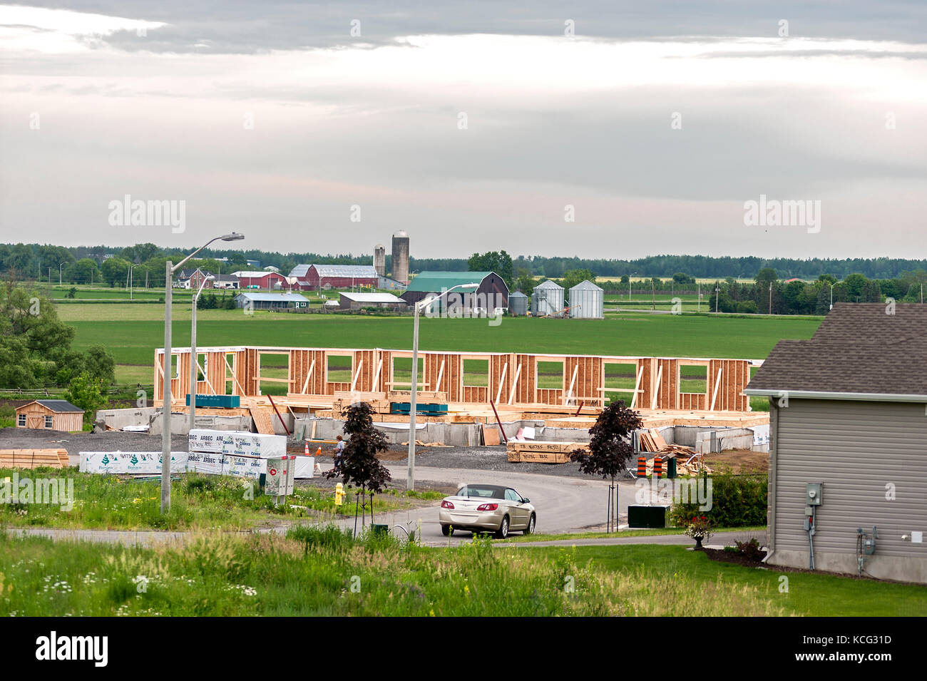 Residential construction borders farmland in Ottawa, Ontario, Canada Stock Photo