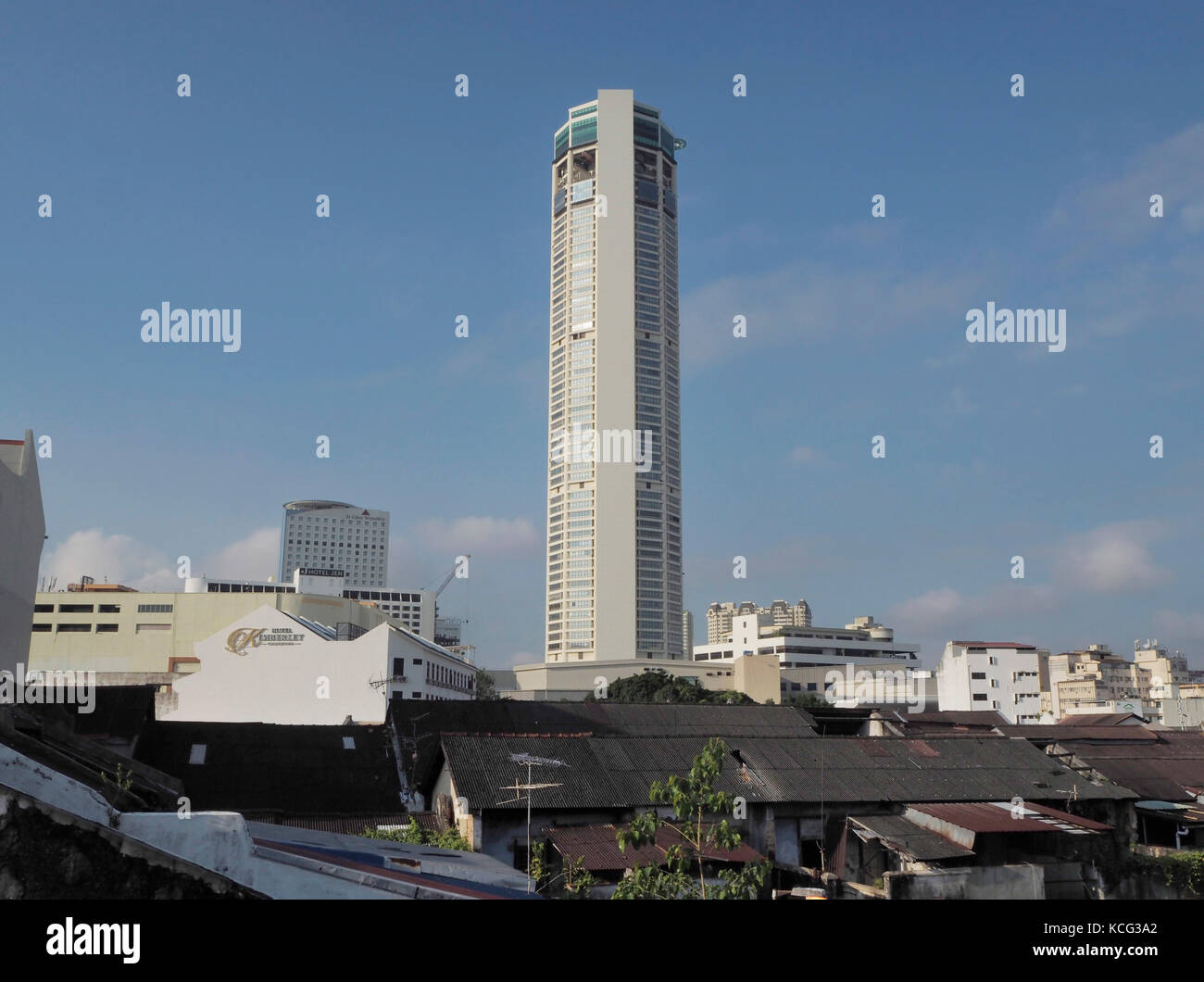 Komtar Tower in Penang, Malaysia. On the foreground are old traditional buildings. Stock Photo