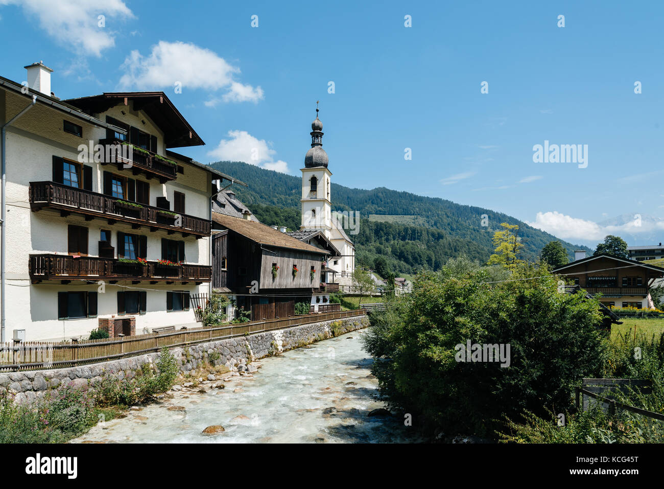 Scenic view of small village and white church in the Alps Stock Photo ...