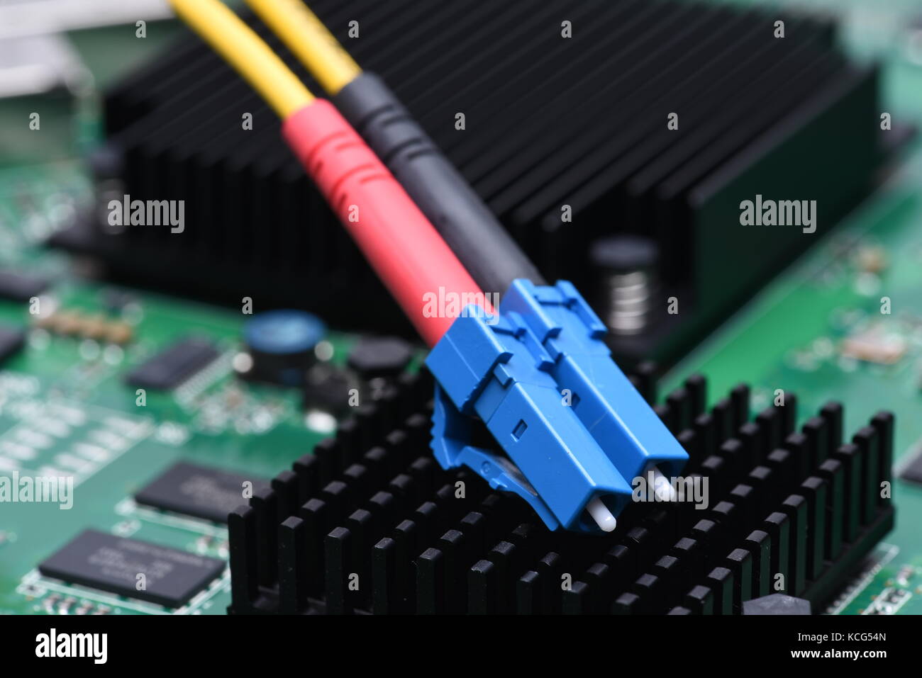 Optical fiber cable patch cord on computer motherboard, optical network technology Stock Photo